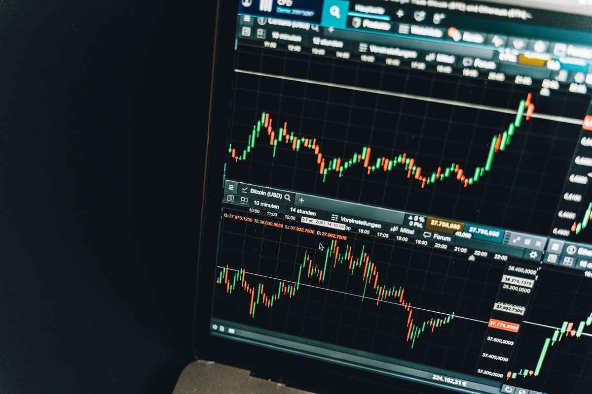 Analyst reviewing financial market data on a computer