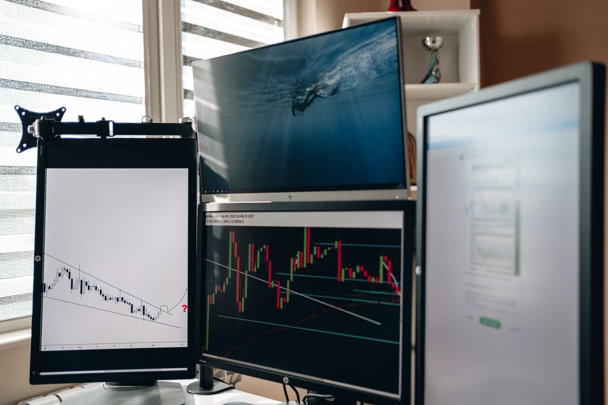 Multiple trading screens displaying financial market charts
